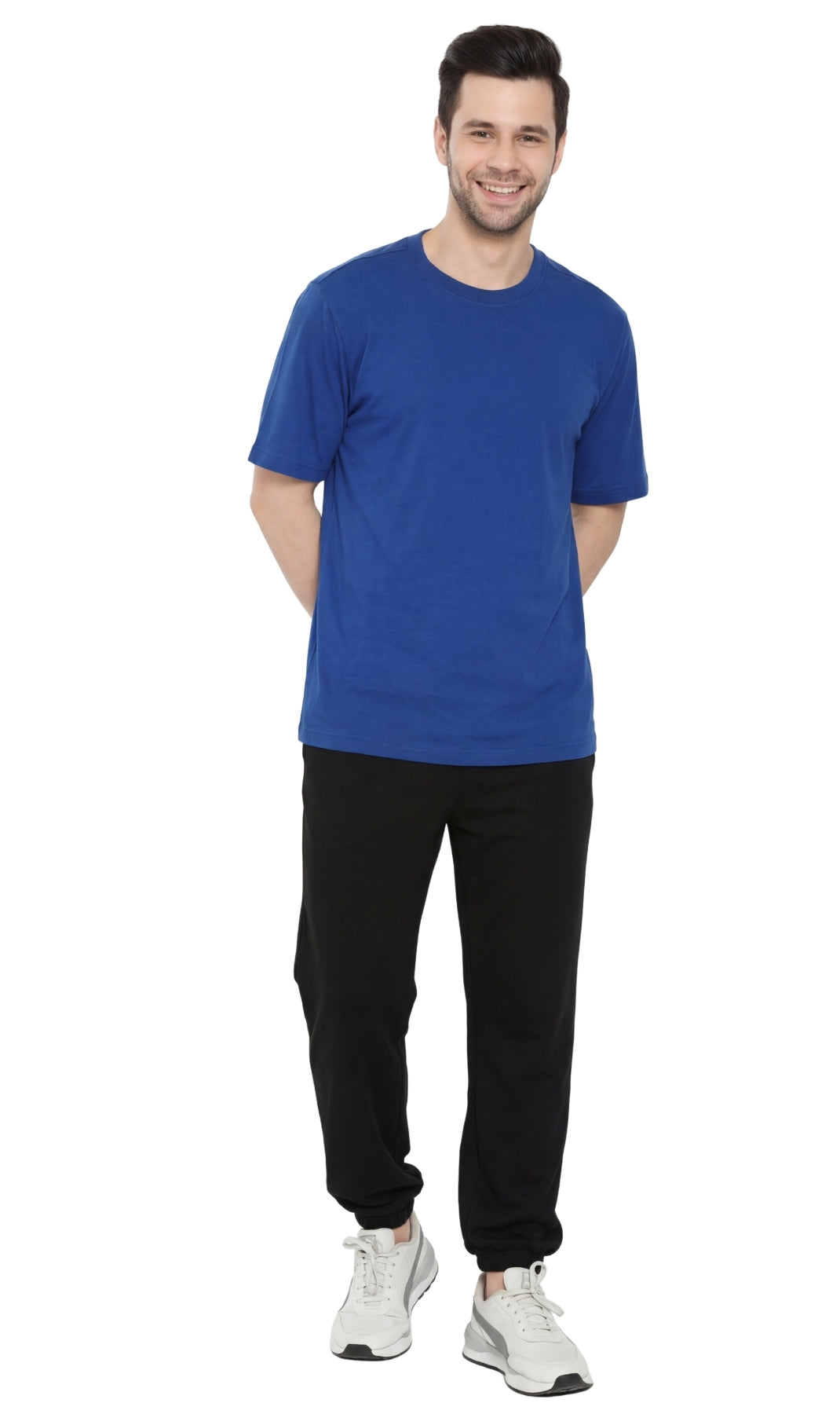 Man wearing a blue t-shirt and black pants on a white background