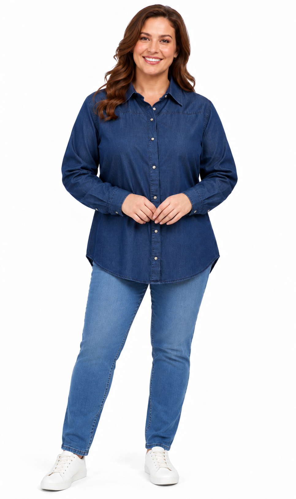 A woman modeling a dark blue long-sleeve button-up shirt and blue jeans against a plain white background.