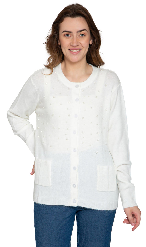A woman wearing a purple cardigan with faux pearl accents on the front and pearl buttons. The cardigan has a crew neck and two front patch pockets.
